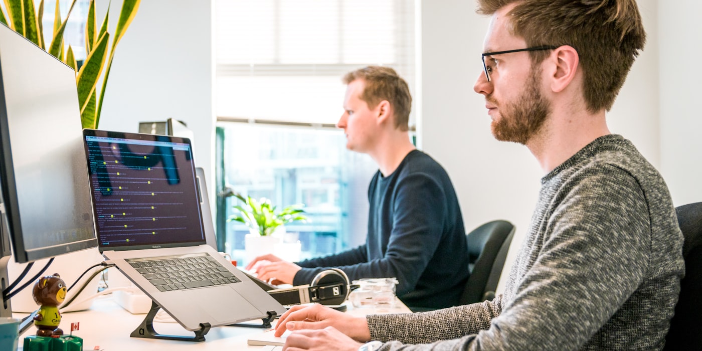 Professionals working with data and multiple monitors