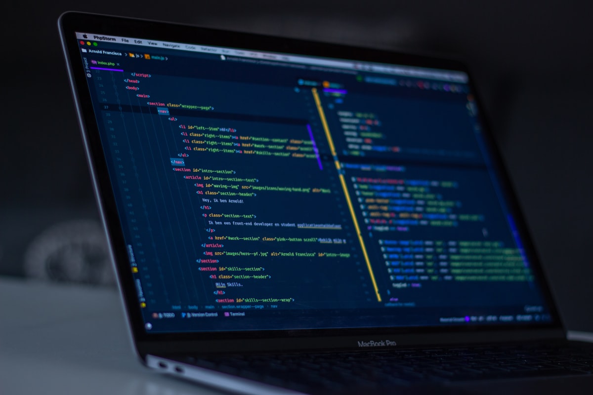 Software development workspace with code on screen